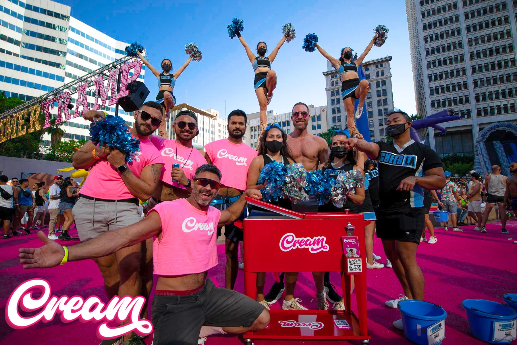 Cream team and community participants at an outdoor event, with branded shirts and a Cream cart